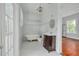 Classic bathroom boasts a clawfoot tub, tiled walls, a vintage chandelier and dark wood vanity at 6904 S Fitzgerald St, Tampa, FL 33616