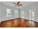 Light-filled bedroom with hardwood floors, neutral paint, and access to outdoor porch at 6904 S Fitzgerald St, Tampa, FL 33616