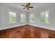 Sun-filled bedroom features beautiful hardwood floors, and three large windows at 6904 S Fitzgerald St, Tampa, FL 33616