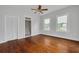 Light-filled bedroom with wood floors, closet, and adjacent bathroom at 6904 S Fitzgerald St, Tampa, FL 33616