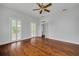 Bright bedroom with hardwood floors, white walls, and access to a covered porch at 6904 S Fitzgerald St, Tampa, FL 33616