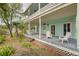 Welcoming porch with ample seating, perfect for enjoying the outdoors and surrounding greenery at 6904 S Fitzgerald St, Tampa, FL 33616