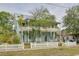 Charming two-story home featuring an inviting porch on both levels, surrounded by lush greenery at 6904 S Fitzgerald St, Tampa, FL 33616