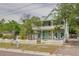 Charming two-story home featuring an inviting porch and a white picket fence at 6904 S Fitzgerald St, Tampa, FL 33616