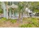 Inviting porch perfect for relaxing, surrounded by mature trees and a charming white picket fence at 6904 S Fitzgerald St, Tampa, FL 33616