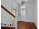 The foyer features pristine white walls and beautiful wood floors, leading to the rest of the home at 6904 S Fitzgerald St, Tampa, FL 33616