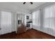 Updated kitchen features stainless steel appliances, white cabinets, hardwood floors, and natural light from windows at 6904 S Fitzgerald St, Tampa, FL 33616
