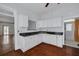 Charming kitchen features white cabinets, dark granite countertops, and an adjacent doorway with natural light at 6904 S Fitzgerald St, Tampa, FL 33616