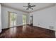 Bright living room with French doors, ceiling fan, and beautiful hardwood floors at 6904 S Fitzgerald St, Tampa, FL 33616