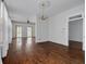 Spacious living room boasting hardwood floors, vintage lighting, and several glass doors allowing plenty of natural light at 6904 S Fitzgerald St, Tampa, FL 33616