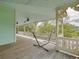 Inviting outdoor porch with hammock frame, ideal for enjoying the surrounding landscape at 6904 S Fitzgerald St, Tampa, FL 33616