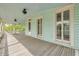 Covered porch with beadboard ceiling, showcasing ample space and natural light with exterior view at 6904 S Fitzgerald St, Tampa, FL 33616
