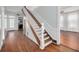 Elegant staircase featuring wooden steps and white railings, connecting the home's floors at 6904 S Fitzgerald St, Tampa, FL 33616
