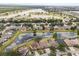 Aerial view of community with multiple ponds lined by homes and mature trees at 7606 Nottinghill Sky Dr, Apollo Beach, FL 33572