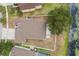 Birds-eye view of home's backyard, with fence, mature tree, and pond view at 7606 Nottinghill Sky Dr, Apollo Beach, FL 33572