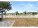 Backyard showing a fence, lake view and brick pavers at 7606 Nottinghill Sky Dr, Apollo Beach, FL 33572
