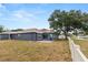 Backyard with enclosed lanai, pavers, and pond view at 7606 Nottinghill Sky Dr, Apollo Beach, FL 33572