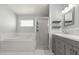 Bright bathroom with a separate shower and tub, and a modern vanity at 7606 Nottinghill Sky Dr, Apollo Beach, FL 33572