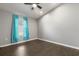 Bedroom featuring wood flooring and natural light from the window at 7606 Nottinghill Sky Dr, Apollo Beach, FL 33572
