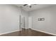 This bedroom is freshly painted with wood-look flooring, closet and fan at 7606 Nottinghill Sky Dr, Apollo Beach, FL 33572