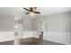 Spacious bedroom featuring a decorative ceiling fan and pristine white wainscoting at 7606 Nottinghill Sky Dr, Apollo Beach, FL 33572