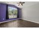 Bedroom with wood flooring and natural light from the large window at 7606 Nottinghill Sky Dr, Apollo Beach, FL 33572