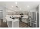 Modern kitchen features stainless steel appliances, gray cabinets, and quartz countertops at 7606 Nottinghill Sky Dr, Apollo Beach, FL 33572