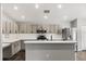 Bright kitchen with stainless steel appliances, breakfast bar, and ample counter space at 7606 Nottinghill Sky Dr, Apollo Beach, FL 33572