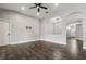 Spacious living room with ceiling fan, TV mount and arched doorway at 7606 Nottinghill Sky Dr, Apollo Beach, FL 33572