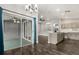 Open living space with sliding glass doors, modern lighting, and access to kitchen at 7606 Nottinghill Sky Dr, Apollo Beach, FL 33572