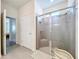 Modern bathroom featuring a spacious glass-enclosed shower with tile surround and chrome fixtures at 8214 Wheat Stone Dr, Zephyrhills, FL 33540