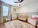 Bright Bedroom with charming decor, a rocking horse, soft area rug, and a comfortable rocking chair at 8214 Wheat Stone Dr, Zephyrhills, FL 33540