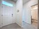 Welcoming foyer featuring a front door with sidelight and tiled flooring at 8214 Wheat Stone Dr, Zephyrhills, FL 33540