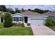 Charming single-story home with a well-manicured lawn and a two-car garage at 8214 Wheat Stone Dr, Zephyrhills, FL 33540
