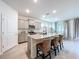Bright kitchen with granite countertops, stainless steel appliances, and seating at the island at 8214 Wheat Stone Dr, Zephyrhills, FL 33540