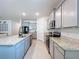 Spacious kitchen with granite countertops, stainless steel appliances, and ample storage at 8214 Wheat Stone Dr, Zephyrhills, FL 33540