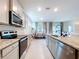 Modern kitchen featuring granite countertops, stainless steel appliances, and ample cabinet space at 8214 Wheat Stone Dr, Zephyrhills, FL 33540