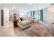 Open-concept living area featuring a large sectional couch and modern decor at 8214 Wheat Stone Dr, Zephyrhills, FL 33540
