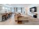 Open-concept living space featuring a plush sectional sofa, kitchen island, and bright dining area with backyard view at 8214 Wheat Stone Dr, Zephyrhills, FL 33540