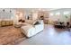 Spacious living space featuring a large sectional sofa, modern decor, and a connected dining area at 8214 Wheat Stone Dr, Zephyrhills, FL 33540