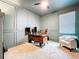 Well-lit home office featuring wood wall panels, a comfortable chair, and a neutral color palette at 8214 Wheat Stone Dr, Zephyrhills, FL 33540