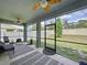 Relaxing screened porch overlooking the backyard and equipped with ceiling fans at 8214 Wheat Stone Dr, Zephyrhills, FL 33540