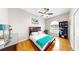 A bedroom with hardwood floors, a ceiling fan, and a comfortable bed at 9535 Norchester Cir, Tampa, FL 33647