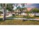 Beautiful single-story home with a well-manicured lawn, mature trees, and lovely landscaping, radiating charm at 9535 Norchester Cir, Tampa, FL 33647