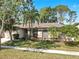 Lovely home showcasing mature trees, a well-kept lawn, and beautiful landscaping, exuding curb appeal at 9535 Norchester Cir, Tampa, FL 33647
