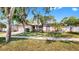 Well-maintained single-story home with mature trees, landscaping, and a two-car garage at 9535 Norchester Cir, Tampa, FL 33647