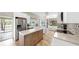 Open kitchen layout with stainless steel appliances, island, and seamless connection to the living area at 9535 Norchester Cir, Tampa, FL 33647