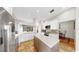 Well-lit kitchen with island, stainless steel appliances, and seamlessly connected to the dining area and living space at 9535 Norchester Cir, Tampa, FL 33647
