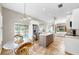 Open layout combining dining and kitchen areas with island, leading into the living space at 9535 Norchester Cir, Tampa, FL 33647