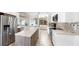 Modern kitchen with stainless steel appliances, center island, and open access to the living space at 9535 Norchester Cir, Tampa, FL 33647